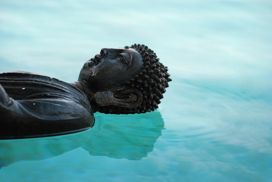 Serene Buddha Statue Floating in Turquoise Water