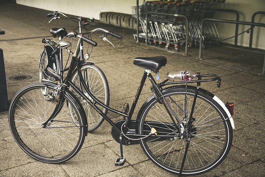 Vintage Black Bicycles Parked on Paved Street