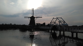 Silhouette of Dutch Windmill and Drawbridge at Sunset