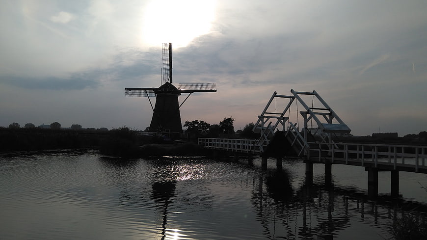 Silhouette of Dutch Windmill and Drawbridge at Sunset