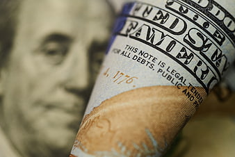 Close-up of rolled US one hundred dollar bill
