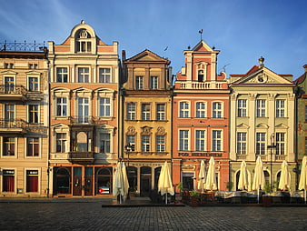 Colorful historic town square with cobblestone street and cafes