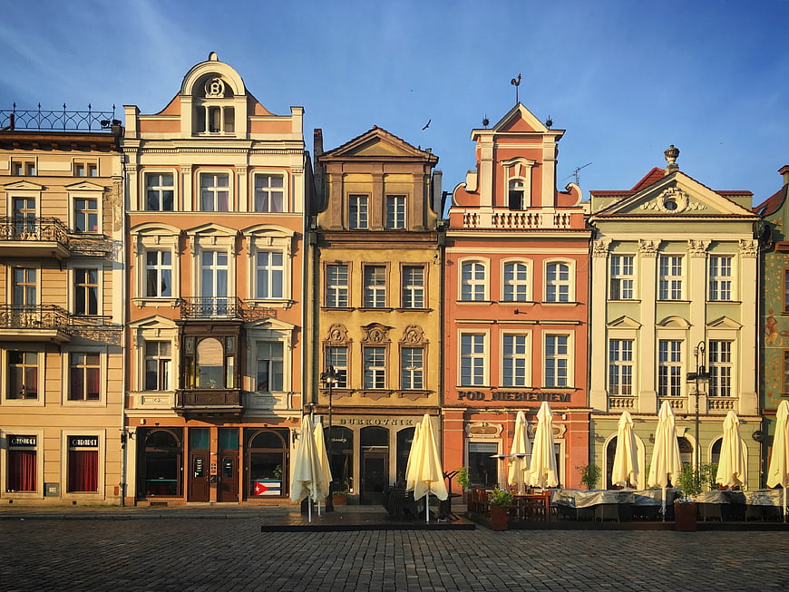 Colorful historic town square with cobblestone street and cafes