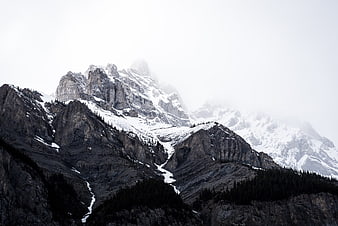 Majestic Snow-Capped Mountain Peaks in Misty Landscape