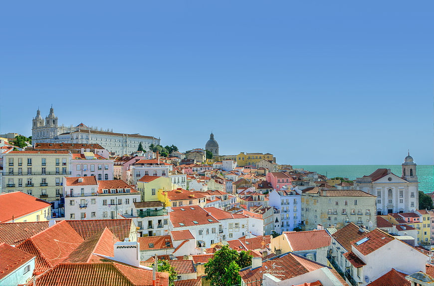 Colorful Lisbon Rooftops and Church Against Blue Sky