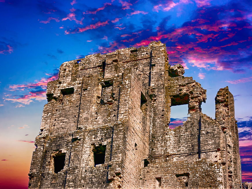 Dramatic Stone Castle Ruins Against Vibrant Sunset Sky