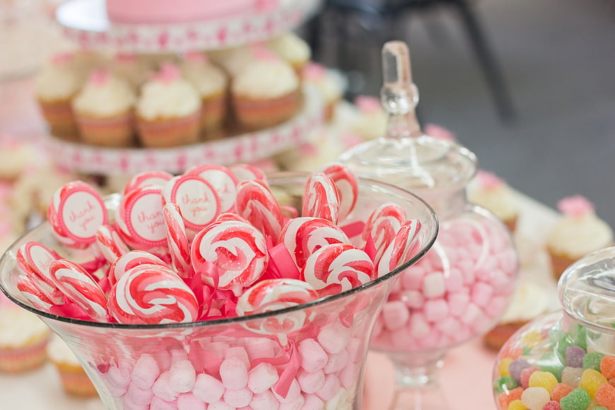 Pink and white candy buffet with peppermint swirls and cupcakes
