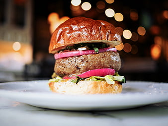 Gourmet Burger with Pickled Onions on White Plate