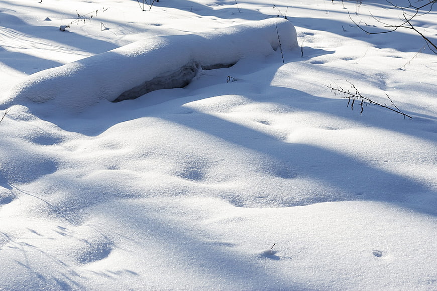 Snowy Winter Landscape with Deep Snowdrifts and Shadows