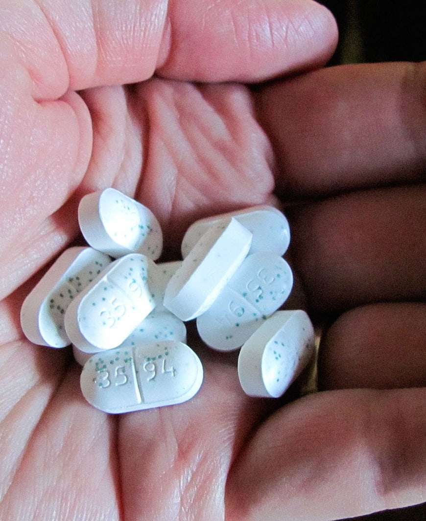 White Medication Tablets In Open Palm Close Up