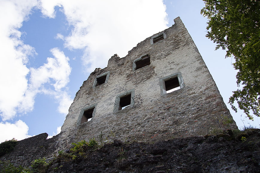 Low angle view of ancient stone castle ruins against blue sky