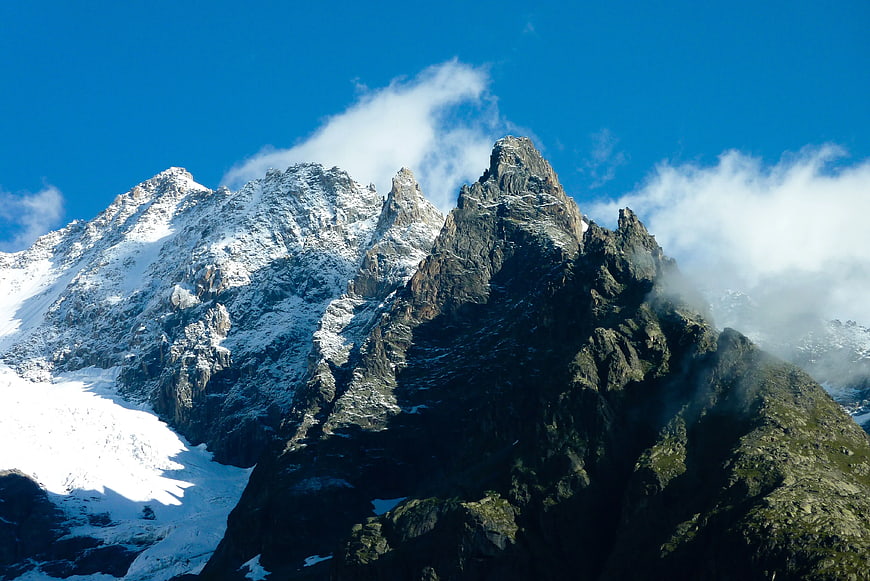Snow-Covered Mountain Peaks Under Blue Sky