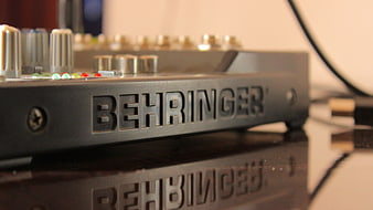 Close-up of Behringer Audio Mixer on Reflective Surface