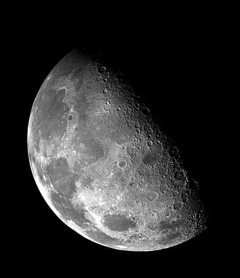 High-Resolution Crescent Moon with Craters Against Black Sky