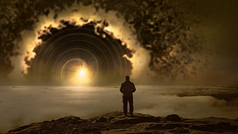 Silhouette of man facing glowing spiral vortex in clouds