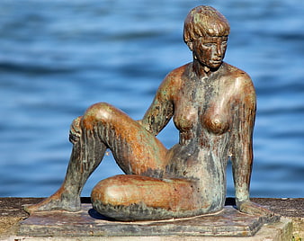 Weathered Bronze Female Sculpture Seated By Lake