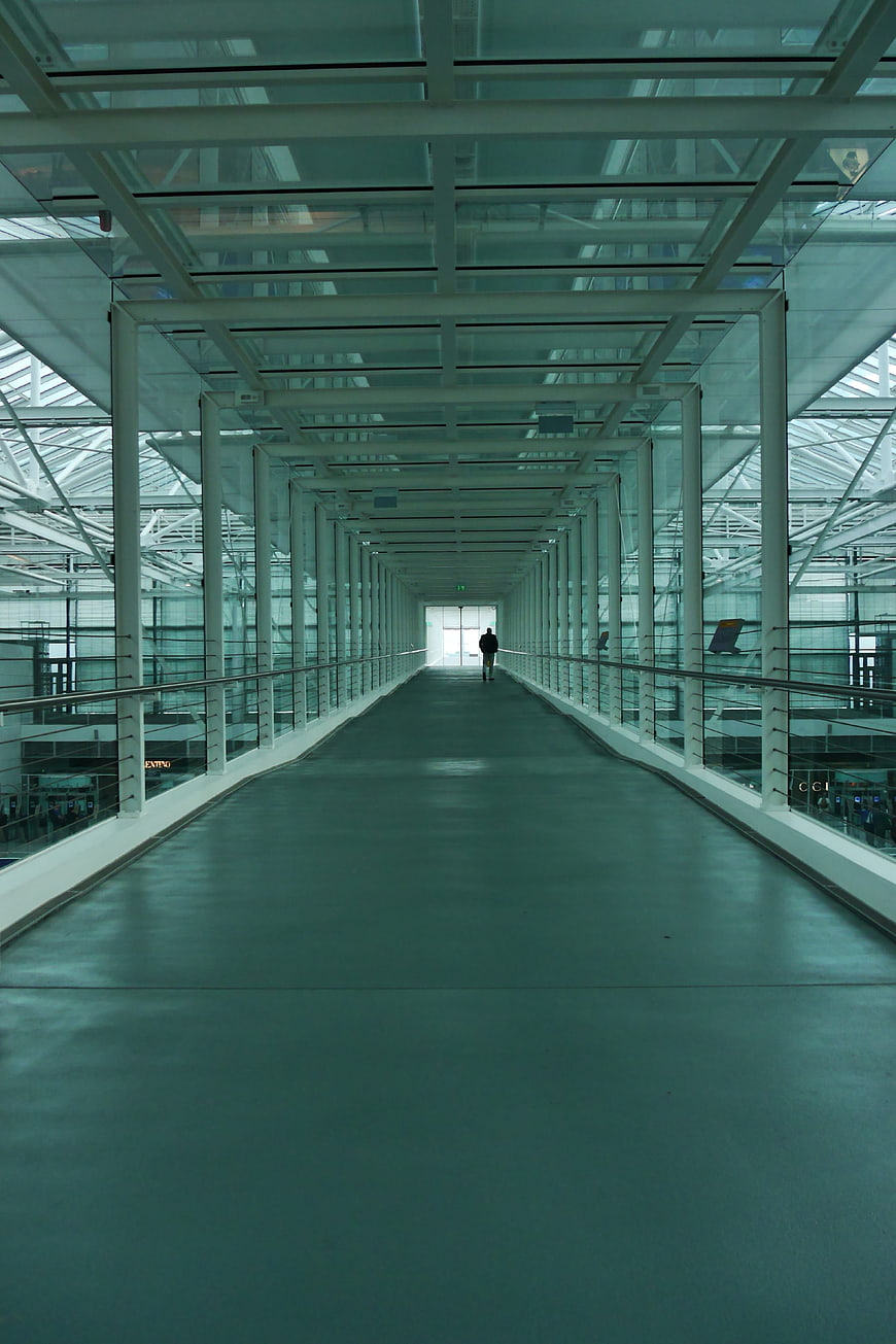 Modern airport terminal walkway with lone figure
