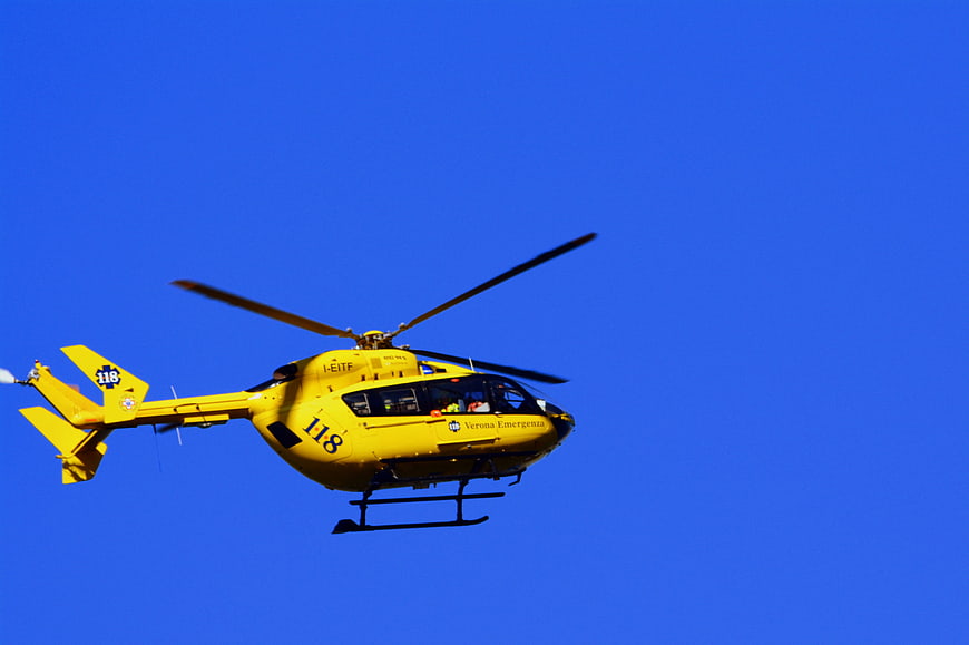 Yellow Emergency Rescue Helicopter Flying in Blue Sky