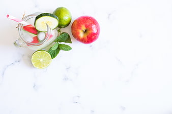 Fresh Detox Water with Apple, Cucumber, and Lime on Marble