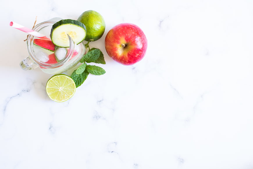 Fresh Detox Water with Apple, Cucumber, and Lime on Marble