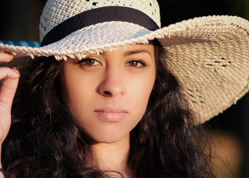 Close-up portrait of woman in straw hat