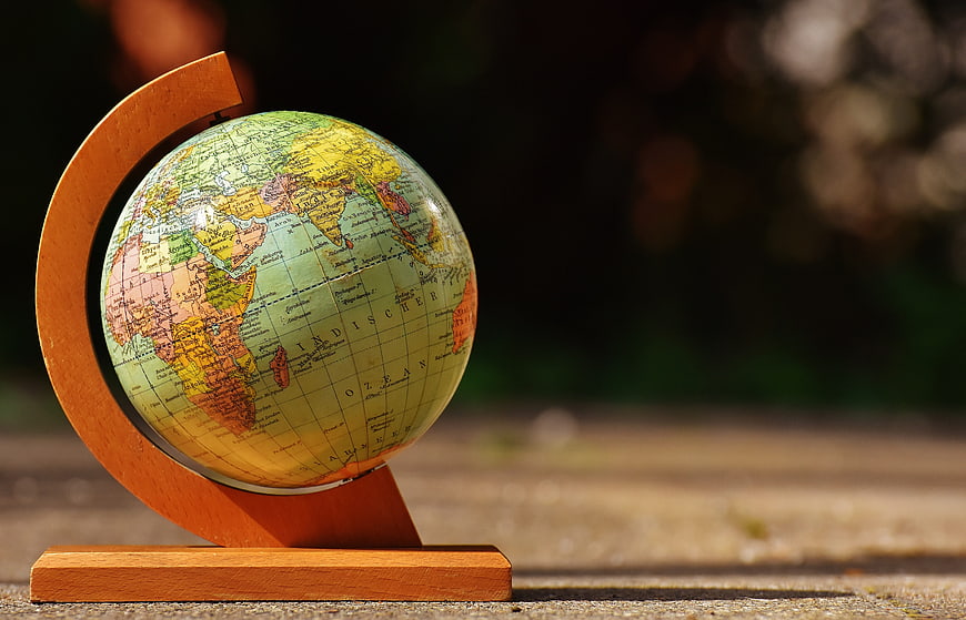 Vintage Globe on Wooden Stand with Blurred Background