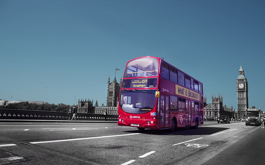 Red Double-Decker Bus Driving Past Big Ben In London