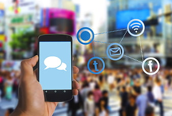 Hand holding smartphone with social media icons and network connection