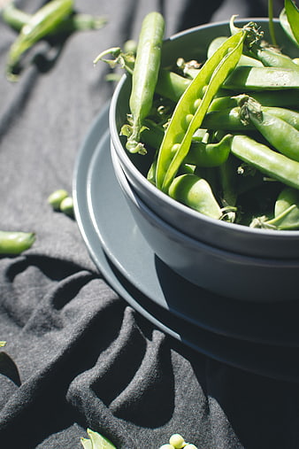 Fresh Green Peas in Blue Bowl on Dark Cloth