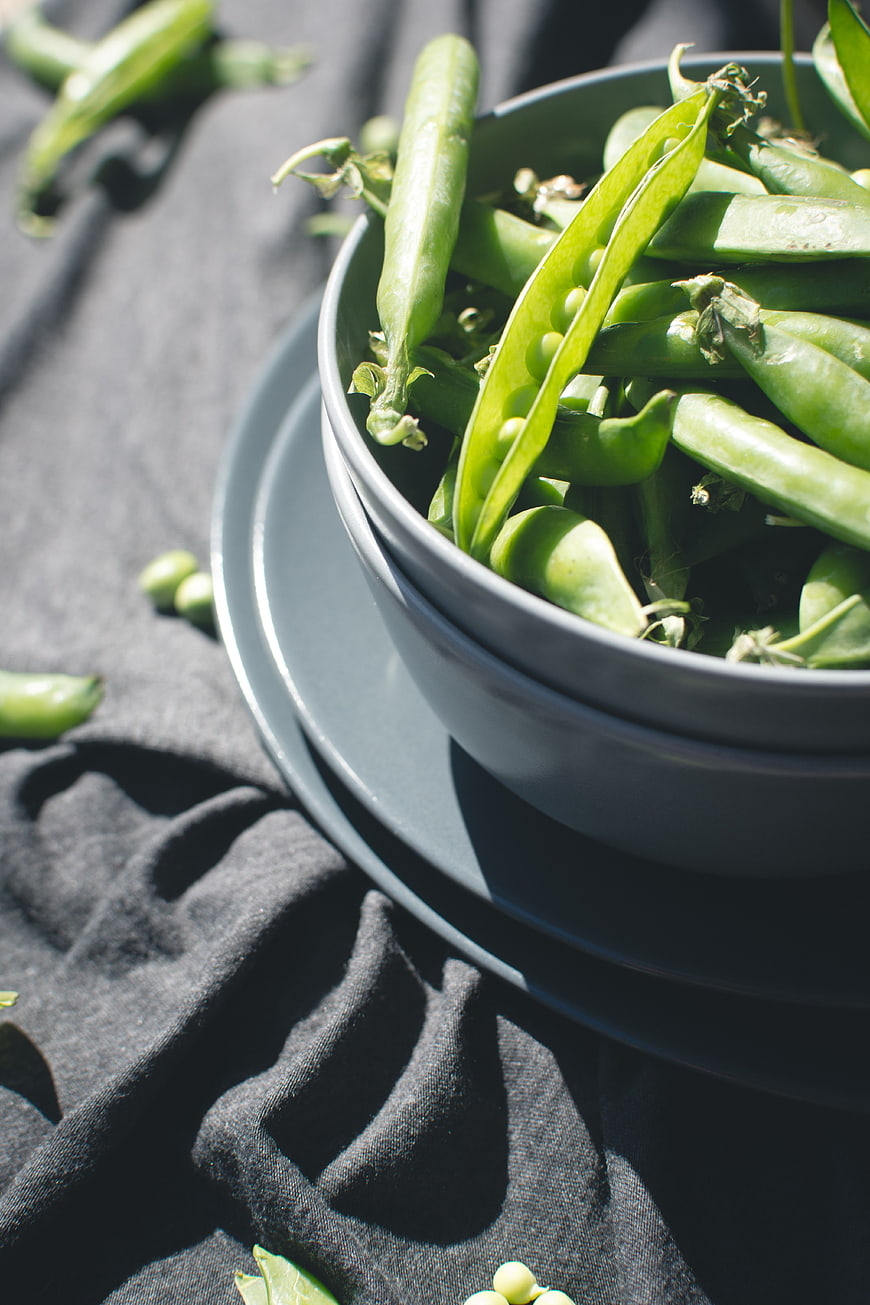 Fresh Green Peas in Blue Bowl on Dark Cloth