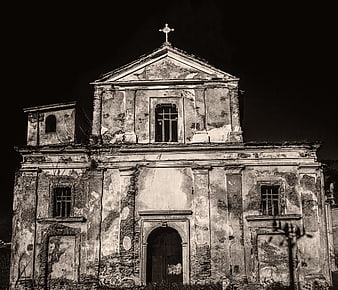 Dilapidated historic church facade in black and white