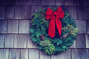 Christmas Wreath with Red Bow on Wooden Shingles