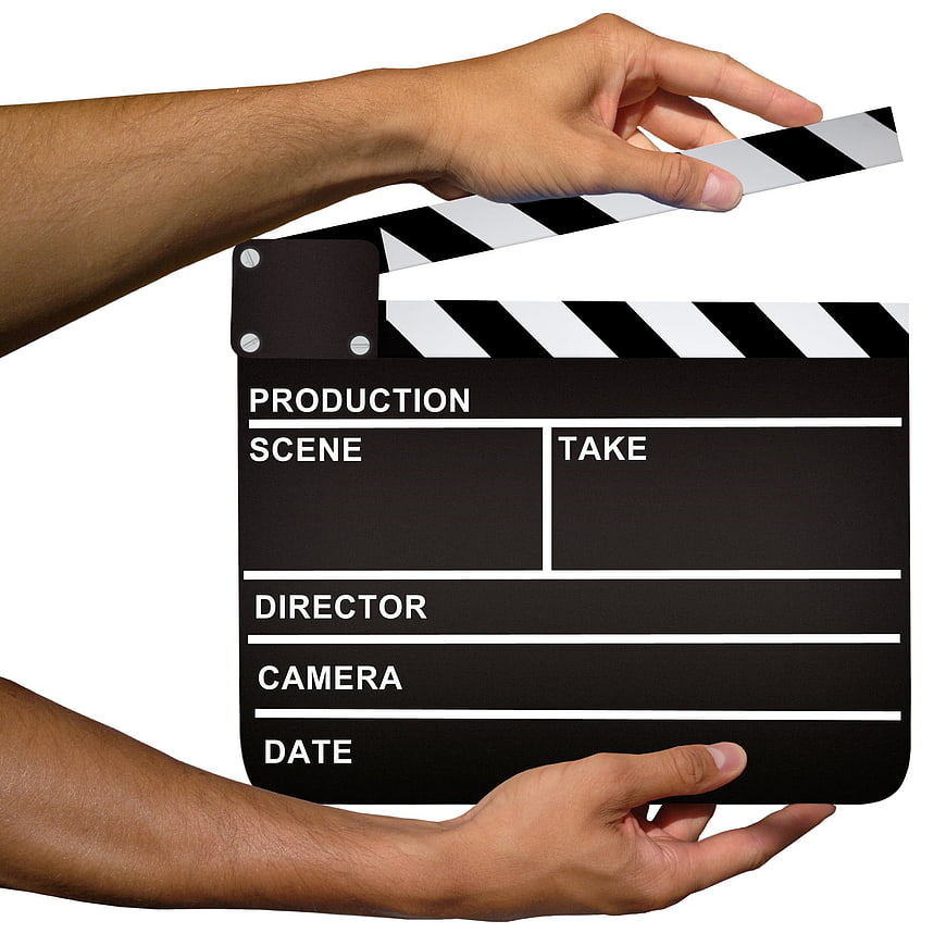 Hands holding open film clapperboard on white background