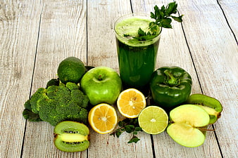 Green Detox Smoothie With Fresh Fruits And Vegetables On Rustic Wood