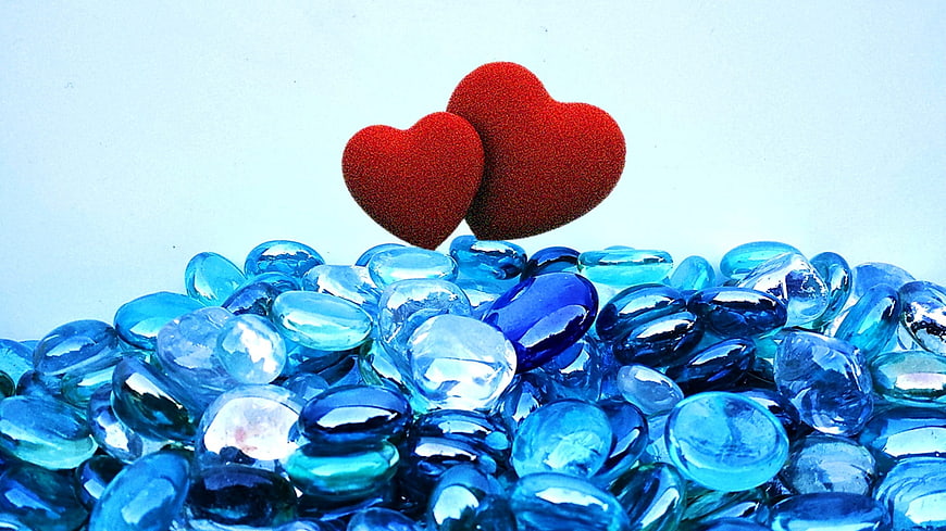 Red Hearts on Blue Glass Stones Background