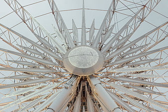 Low angle view of white Ferris wheel structure against sky