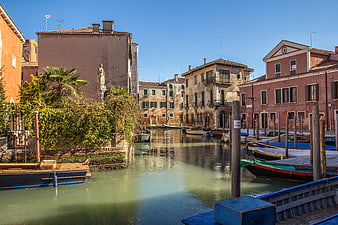 Venice Canal with Moored Boats and Historic Buildings