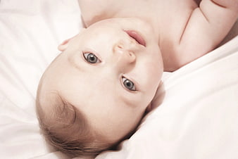 Newborn Baby Boy Lying On White Bedding
