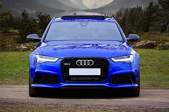 Front View Blue Audi RS6 Avant On Gravel Road With Mountain Lake Background