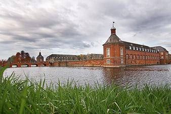 Historic red brick castle with moat and bridge