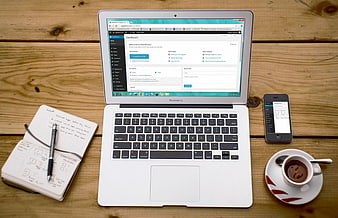 MacBook Air with WordPress Dashboard on Wooden Desk