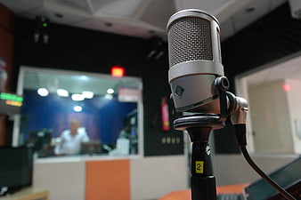 Close-up of silver condenser microphone in recording studio