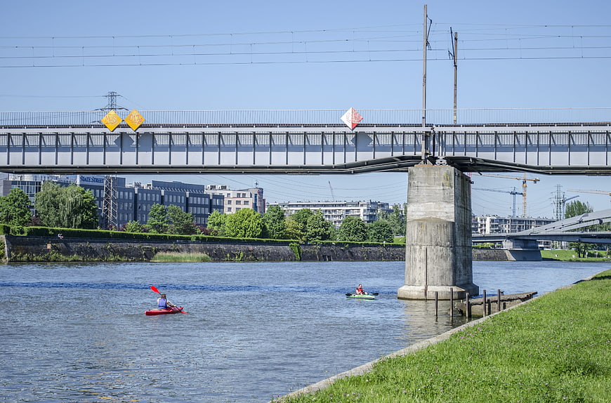 Kayakers on the Vistula River under a bridge in Krakow
