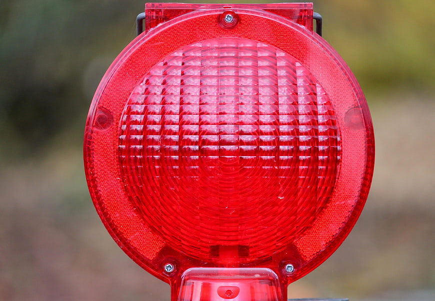 Close-up of red warning light on construction site