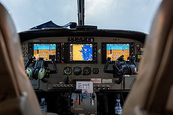 Cockpit view of airplane dashboard with navigation screens