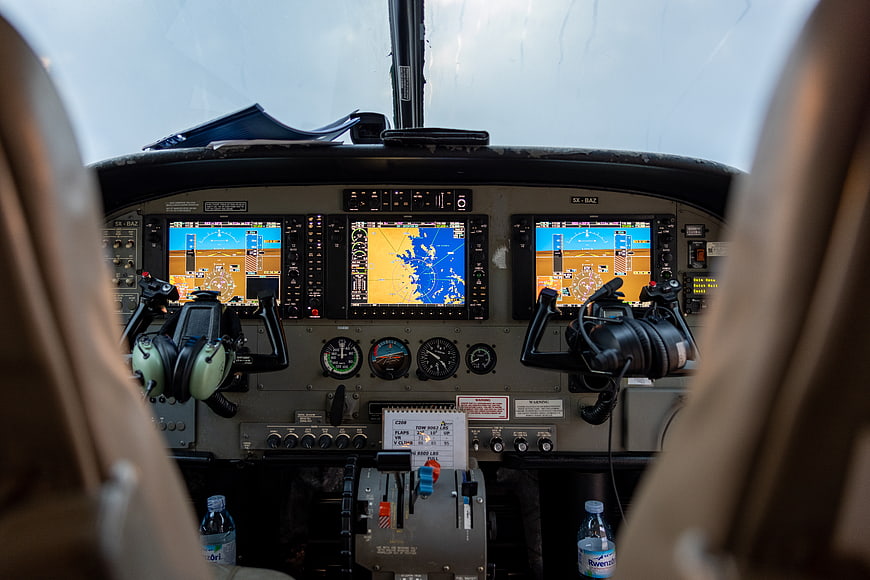 Cockpit view of airplane dashboard with navigation screens