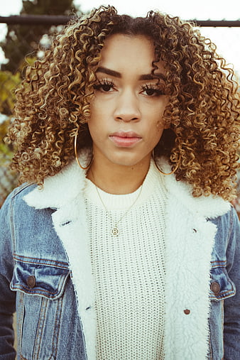 Portrait of Woman with Curly Blonde Hair and Denim Jacket