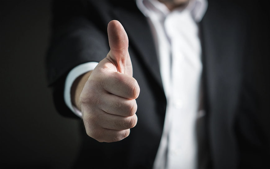 Businessman Giving Thumbs Up Gesture in Suit