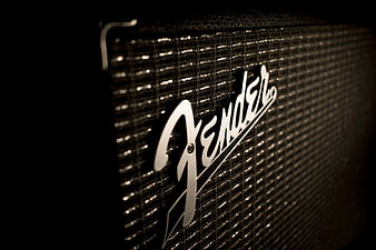 Close-up of Fender Guitar Amplifier Logo on Black Background