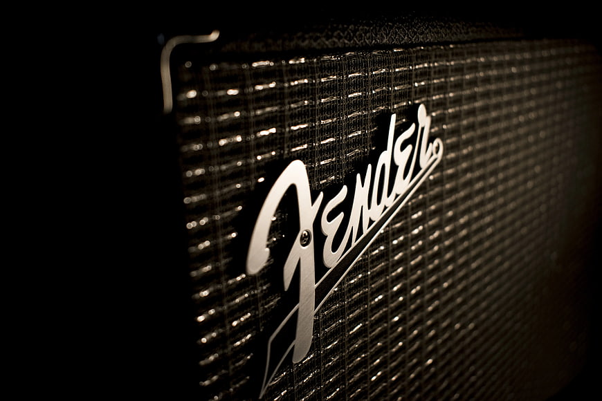 Close-up of Fender Guitar Amplifier Logo on Black Background